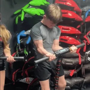 Close-up of an athlete performing bicep curls with dumbbells at ApeStrength.