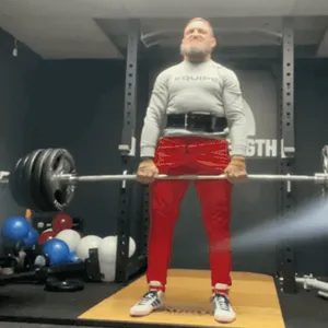 Athlete executing a barbell deadlift, a full-body strength exercise at ApeStrength.