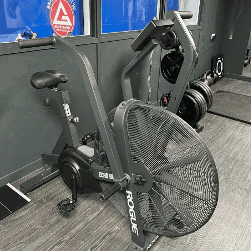 Athlete performing breathing exercises on an exercise bike, focusing on Oxygen Advantage principles at ApeStrength.